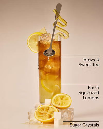 Brewed sweet tea with lemons and sugar crystals on a beige background. Purchase from americanbodycare.co.uk