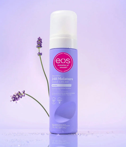 Eos 24H Moisture Shave Cream bottle on a purple background with lavender flowers. purchase from americanbodycare.co.uk