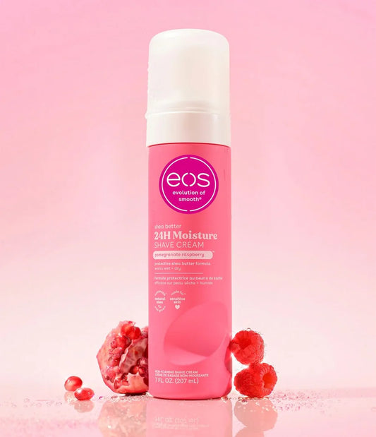 Pink bottle of eos 24H Moisture Shave Cream on a pink background with raspberries. purchase from americanbodycare.co.uk