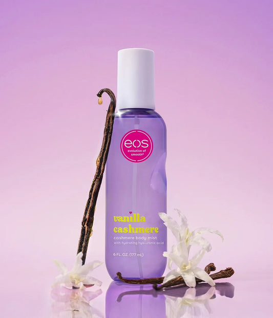 EOS Vanilla Cashmere hand lotion with vanilla beans and flowers on a purple background. Purchase from americanbodycare.co.uk