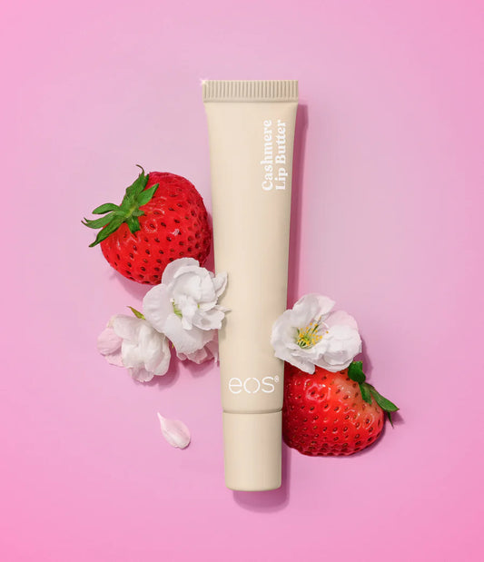 Lip balm tube with strawberries and flowers on a pink background.Purchase from www.americanbodycare.co.uk