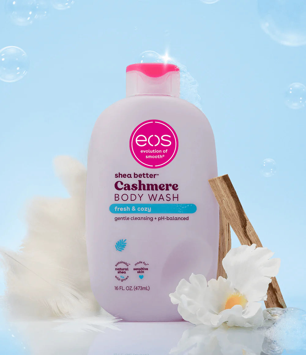 eos shea butter cashmere body wash bottle with a floral and cinnamon stick background. Purchase from americanbodycare.co.uk