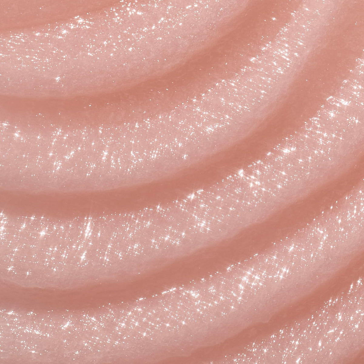 Close-up of pink glittery slime with a glossy finish. A jar of Tree Hut Moroccan Rose Shea Sugar Scrub with a peach-pink body and a metallic copper lid, shown on a white background with a brown 'America's #1 Body Scrub Brand' . purchase from www.americanbodycare.co.uk