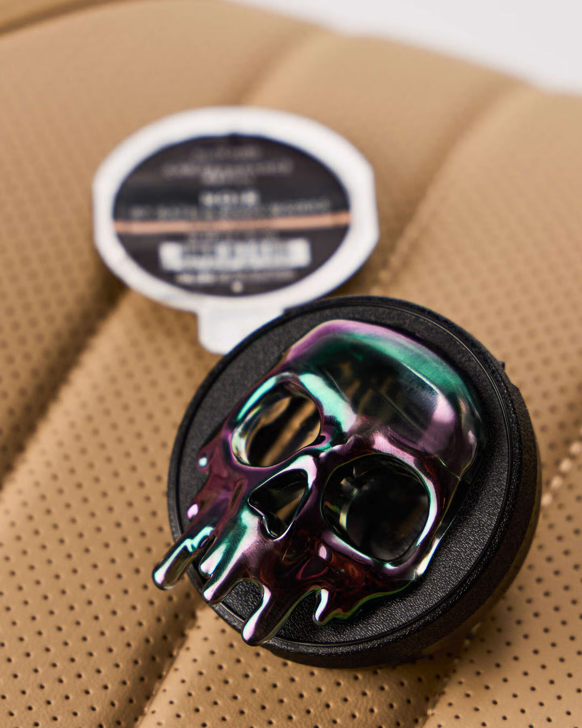 Colorful skull-shaped object on a textured brown surface with a label in the background. Skull-shaped object with colorful design on a white background. purchase from www.americanbodycare.co.uk