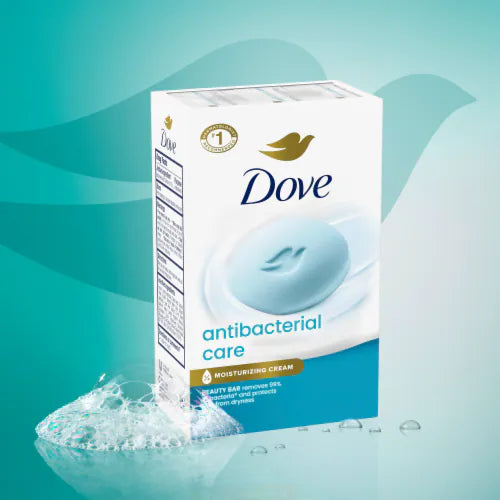 A box of Dove Antibacterial Care moisturizing cream beauty bar soap, shown on a teal and light blue background with a splash of soap bubbles in the lower left corner. Purchase from www.americanbodycare.co.uk 
