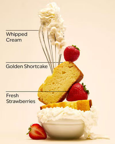 Golden shortcake with whipped cream and fresh strawberries on a beige background