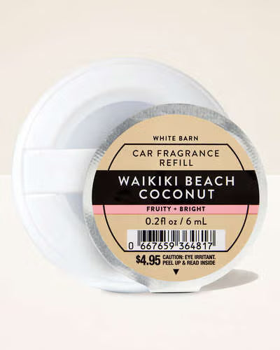 Car fragrance refill labeled 'Waikiki Beach Coconut' by White Barn on a beige background. Purchase from www.americanbodycare.co.uk 