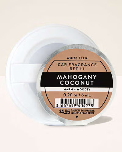 Car fragrance refill container labeled 'Mahogany Coconut' on a beige background. Purchase from www.americanbodycare.co.uk 