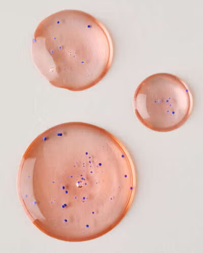 Three peach-colored ceramic plates with speckled patterns on a light gray background. Purchase from americanbodycare.co.uk 