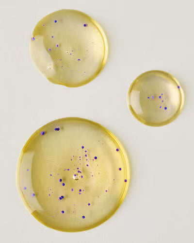 Three round, yellowish plates with speckles on a light gray background