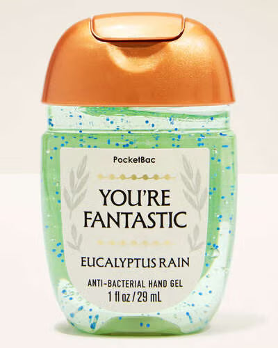 Hand gel bottle labeled 'You're Fantastic Eucalyptus Rain' with a gold cap on a light beige background. purchase from www.americanbodycare.co.uk