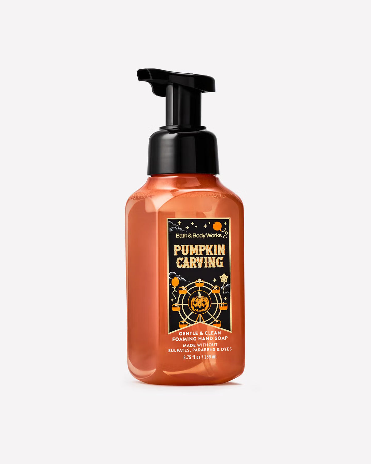 A bottle of Bath & Body Works 'Pumpkin Carving' scented hand soap on a light gray background. The bottle is a translucent orange color with a black pump dispenser and a black, gold, and orange label. purchase from www.americanbodycare.co.uk