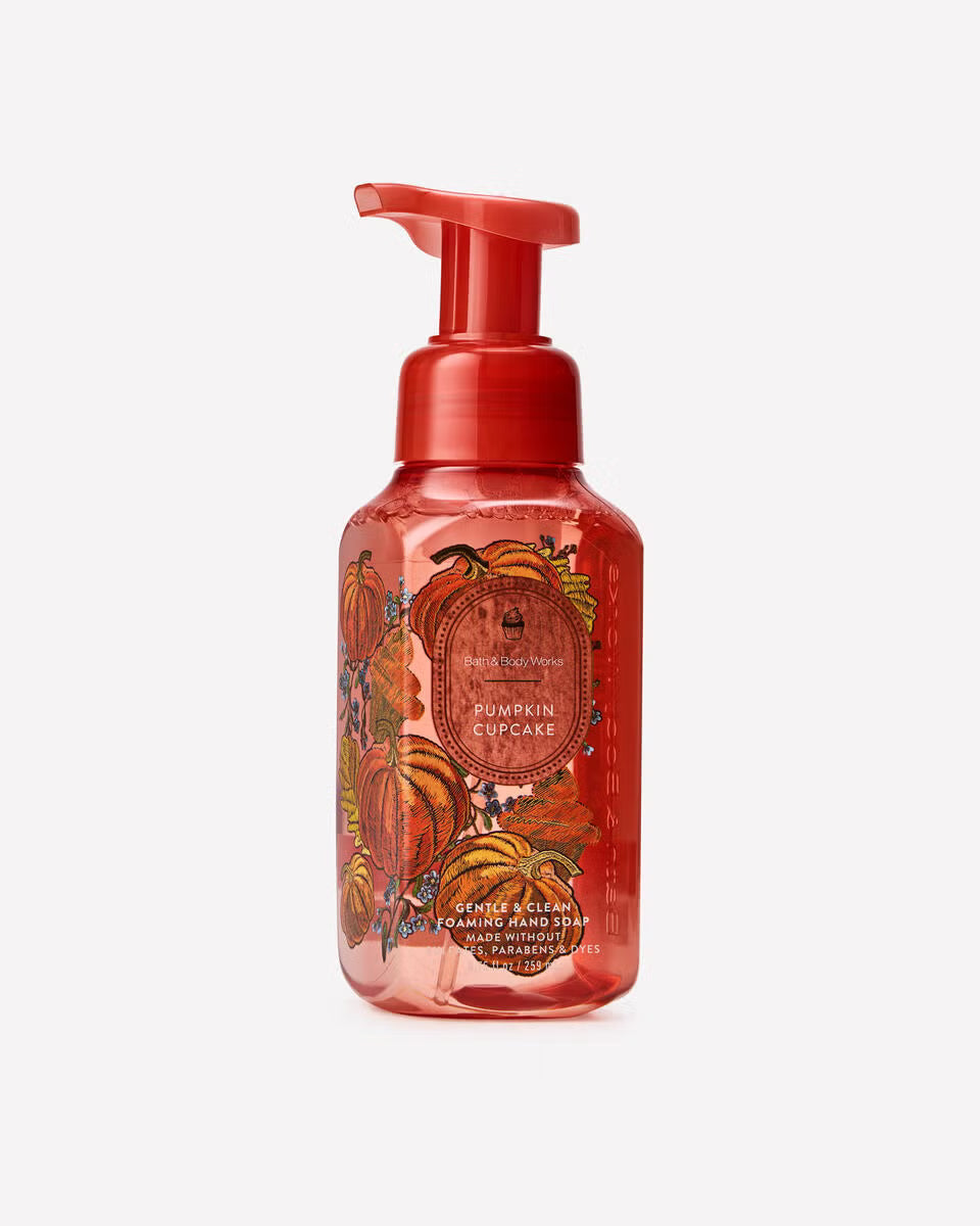 A bottle foaming hand soap in the  Pumpkin Spice flavor, featuring a translucent red bottle with a matching red pump dispenser and an autumn-themed label with illustrations of pumpkins and fall leaves. Purchase from www.americanbodycare.co.uk 