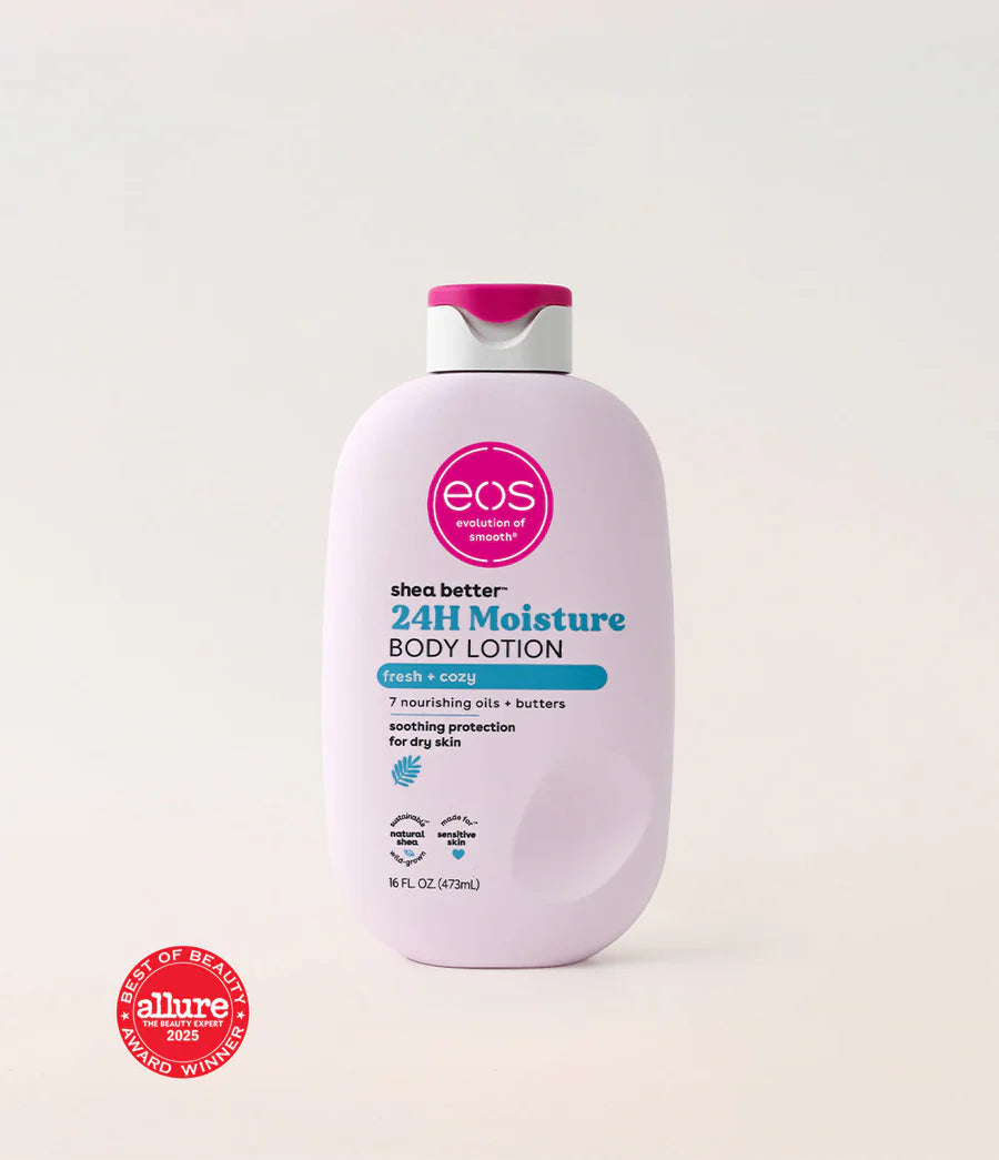 A bottle of EOS Shea Better 24H Moisture Body Lotion in a pale pink color with a magenta and white cap, set against a light beige background. An Allure Best of Beauty 2023 Winner seal is visible in the bottom-left corner. Purchase from www.americanbodycare.co.uk 