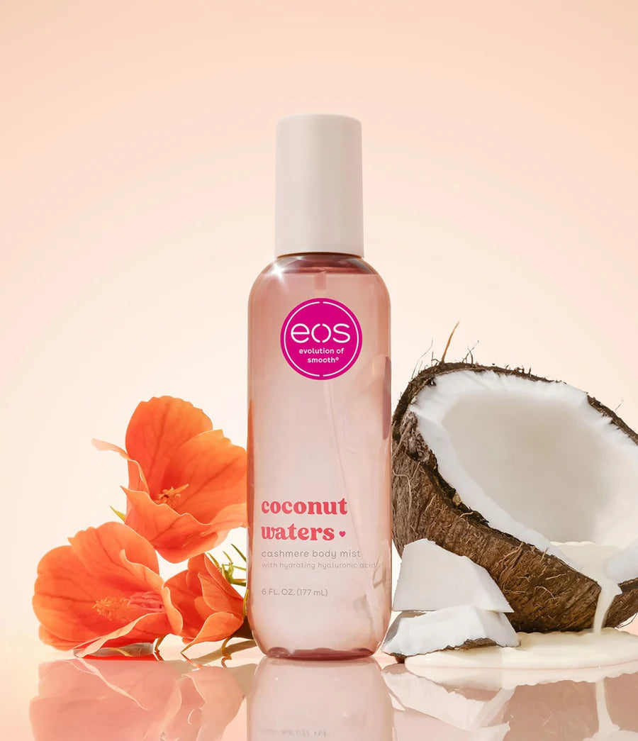 Bottle of eos coconut waters hand cream with a coconut and flowers on a peach background. Purchase from americanbodycare.co.uk 
