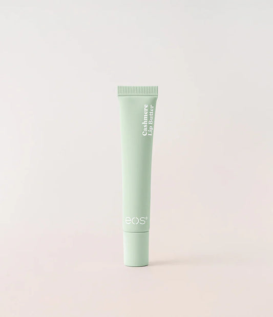 A light mint green squeeze tube of BOS Cashmere Lip Butter standing upright against a soft, light beige background. Purchase from www.americanbodycare.co.uk 