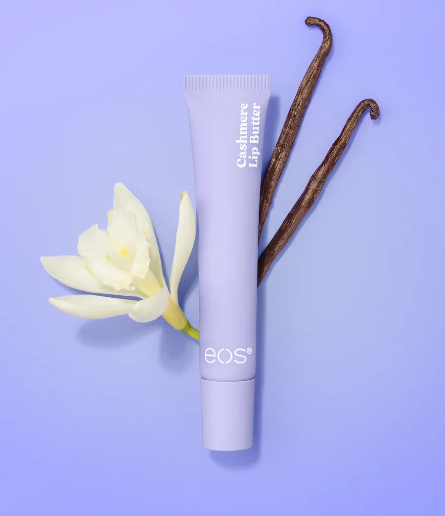 eos lip balm tube with a vanilla bean and flower on a purple background. Purchase from www.americanbodycare.co.uk 