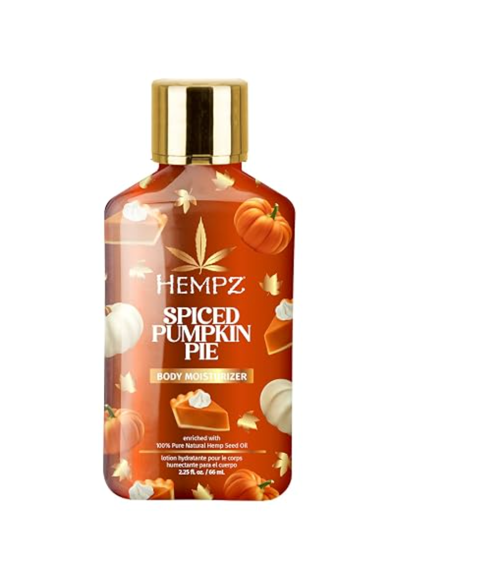 A bottle of Hempz Spiced Pumpkin Pie body moisturizer with a gold cap, featuring a warm orange label decorated with pumpkin, cinnamon, and nut illustrations, on a plain white background. www.americanbodycare.co.uk