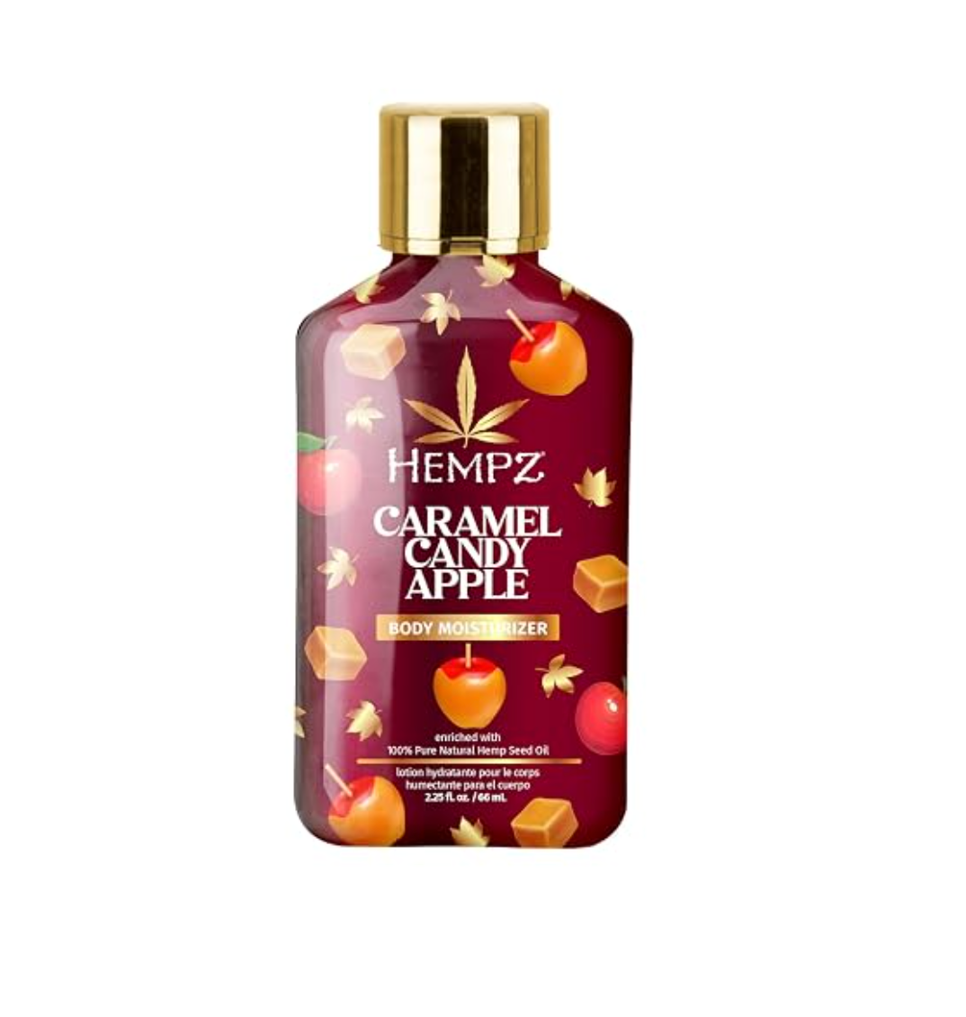 A bottle of Hempz Caramel Candy Apple Body Butter with a gold cap and a dark red label decorated with illustrations of apples, candies, and leaves. www.americanbodycare.co.uk