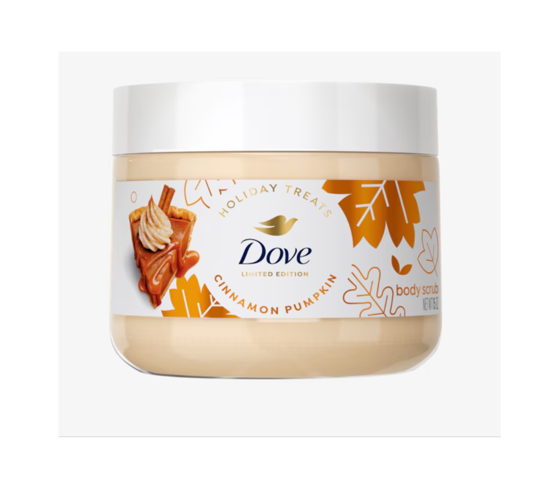 Dove Limited Edition Cinnamon Pumpkin body scrub in a clear jar with a white lid, featuring a festive autumn-themed label with pumpkin leaves and a cinnamon pie illustration.