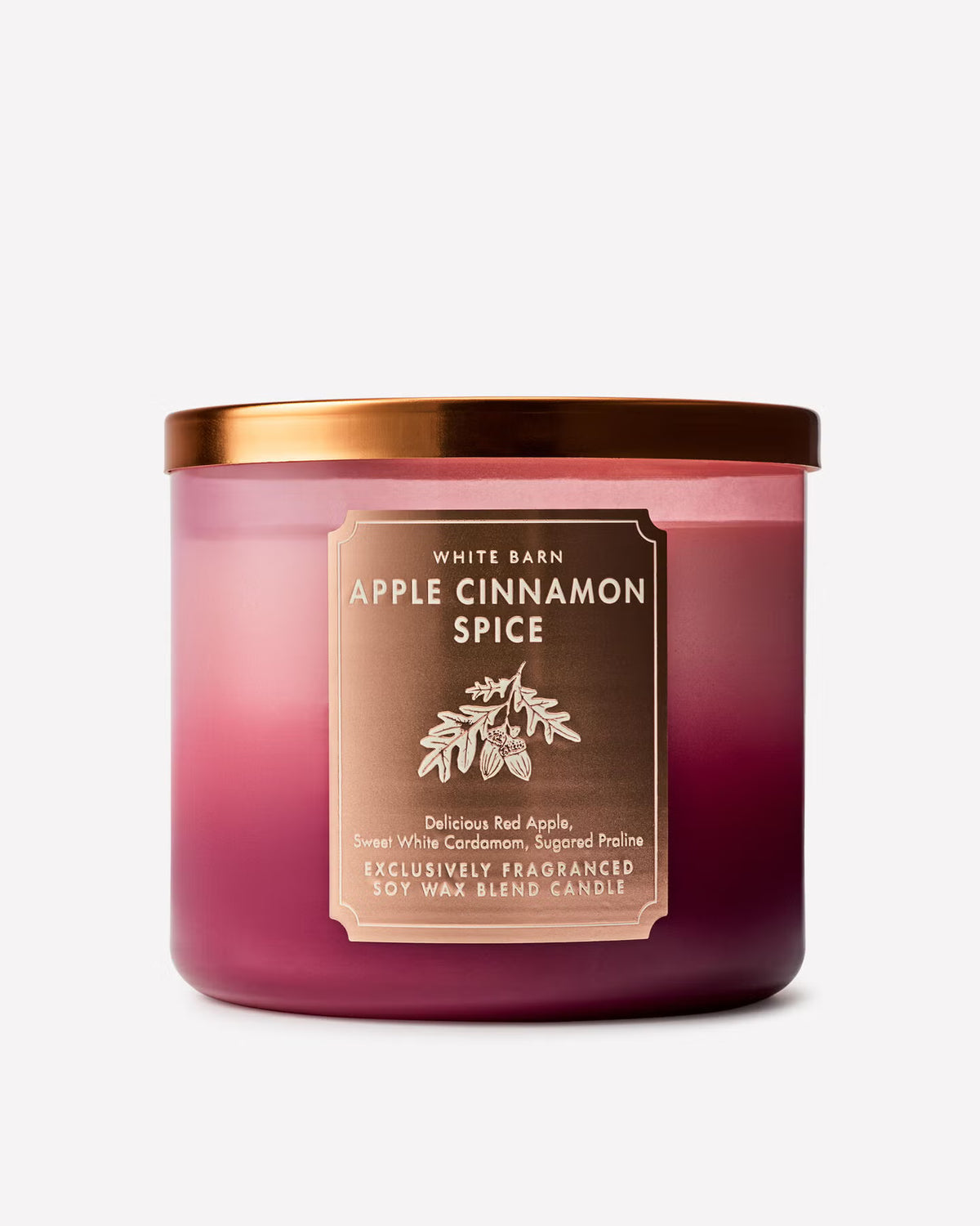 A White Barn Apple Cinnamon Spice soy wax candle in a translucent pink glass jar with a metallic rose gold lid and a matching brown label. Purchase from www.americanbodycare.co.uk