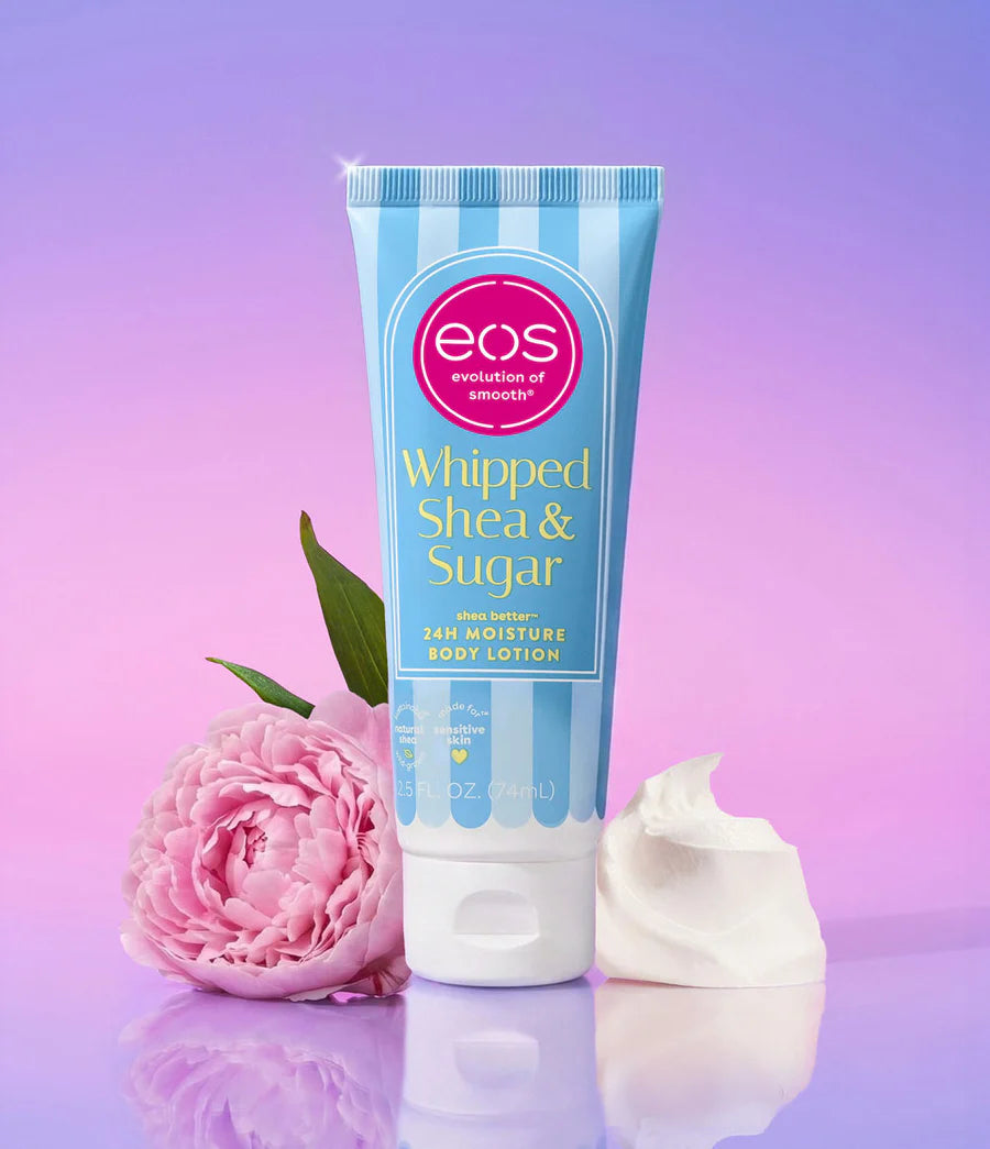 Eos Whipped Shea & Sugar body lotion with a pink flower on a purple gradient background. Purchase from www.americanbodycare.co.uk 