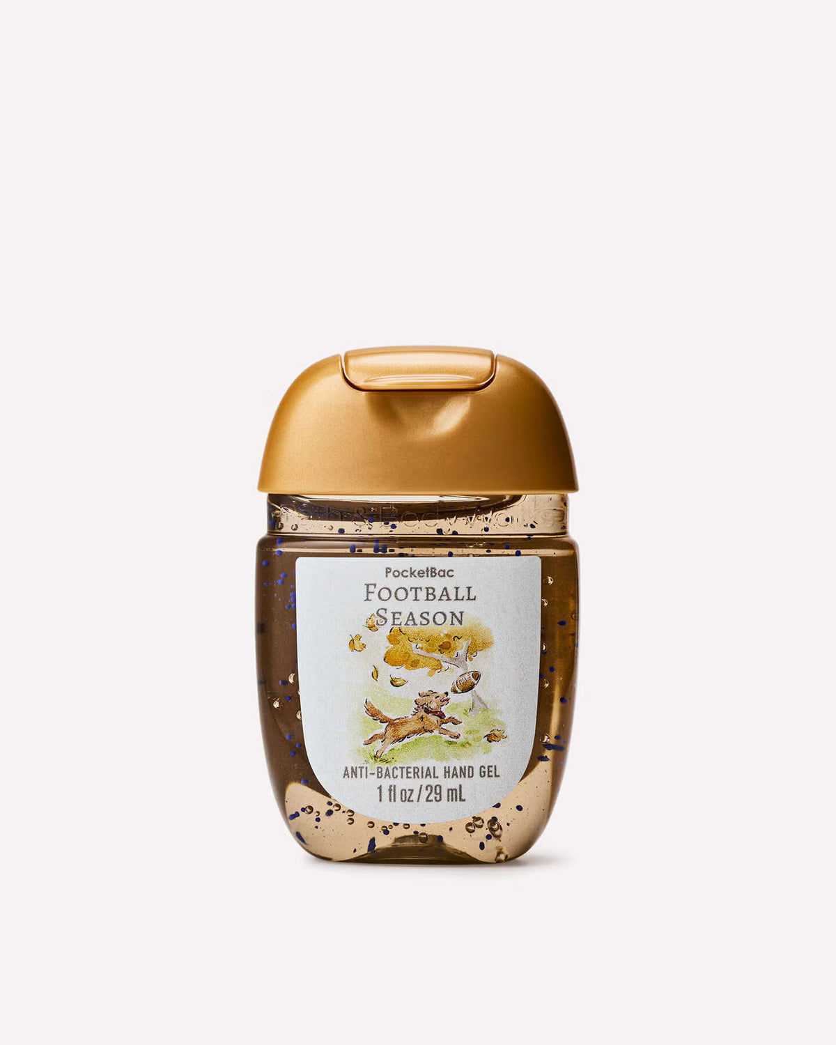 A Pocket the Rac Football Season anti-bacterial hand gel bottle by Bath & Body Works, featuring a metallic gold cap and a white label with autumn-themed illustrations, set against a plain light gray background. www.americanbodycare.co.uk
