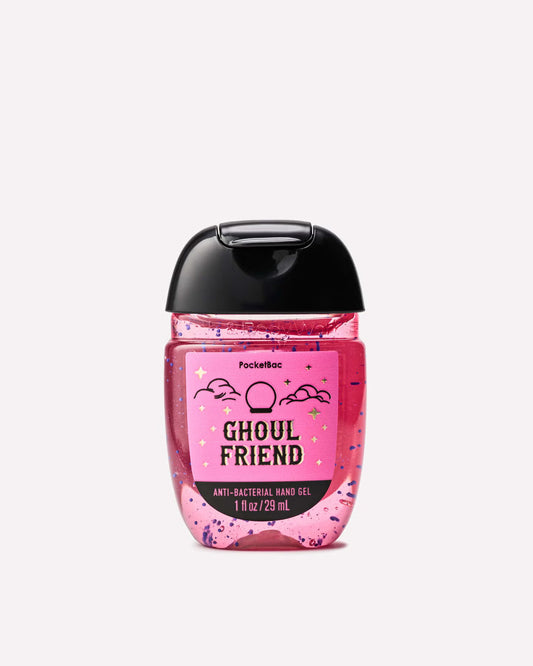 A Pocketbac Ghoul Friend anti-bacterial hand gel bottle with a pink glittery liquid, a black flip-top cap, and a pink label with black text and cloud illustrations, set against a plain light gray background. purchase from www.americanbodycare.co.uk