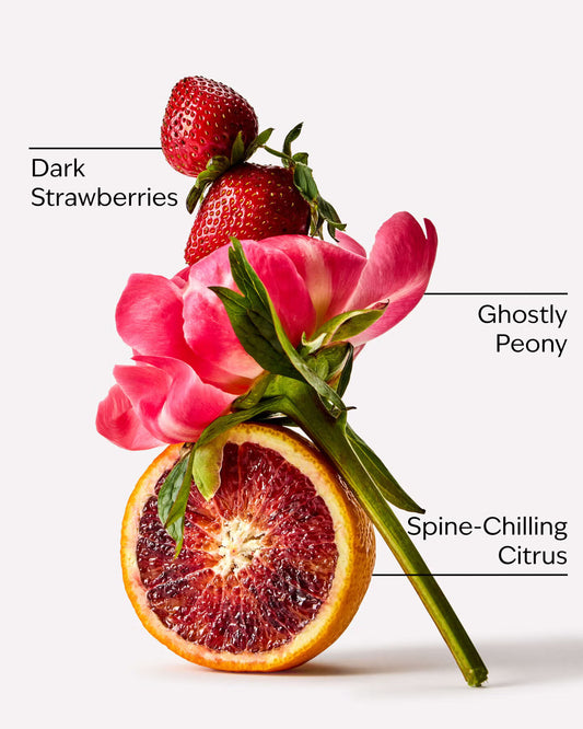 Arrangement of dark strawberries, pink tulips, and a sliced blood orange on a white background. A Pocketbac Ghoul Friend anti-bacterial hand gel bottle with a pink glittery liquid, a black flip-top cap, and a pink label with black text and cloud illustrations, set against a plain light gray background. purchase from www.americanbodycare.co.uk