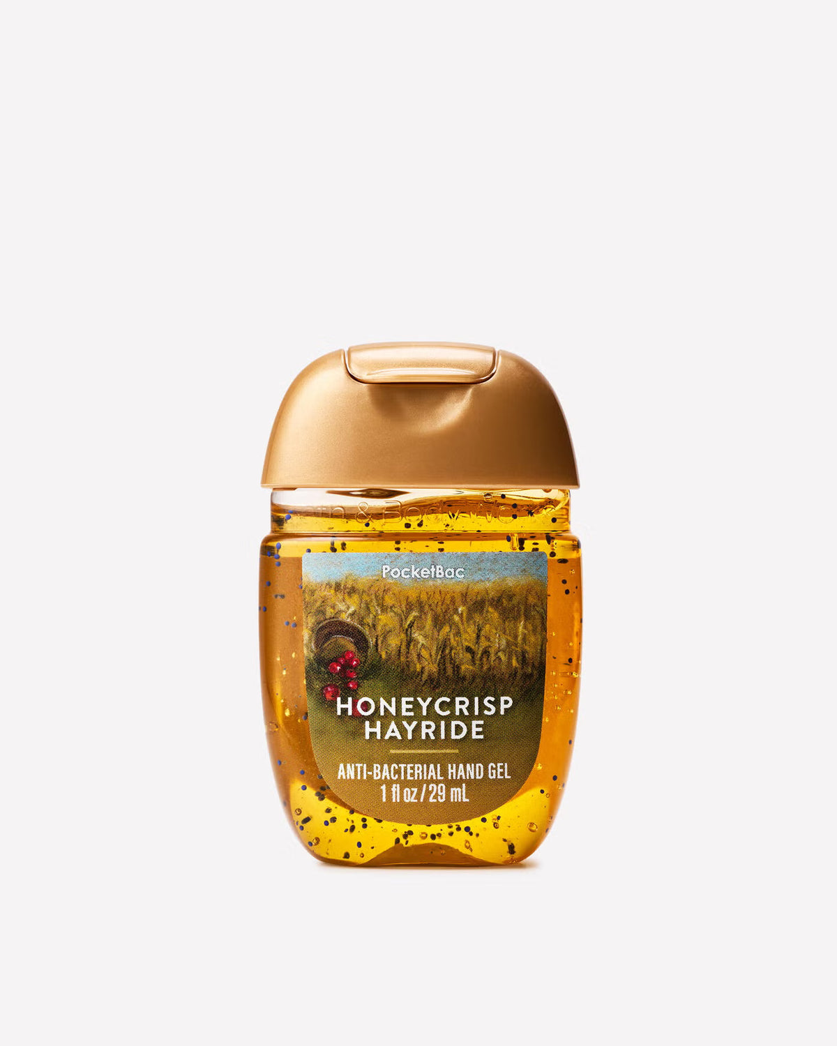 A bottle of Bath Body Works Honeycrisp Hayride anti-bacterial hand gel, featuring a metallic gold cap and a label depicting a golden field with a ladybug, set against a plain light gray background. purchase from www.americanbodycare.co.uk