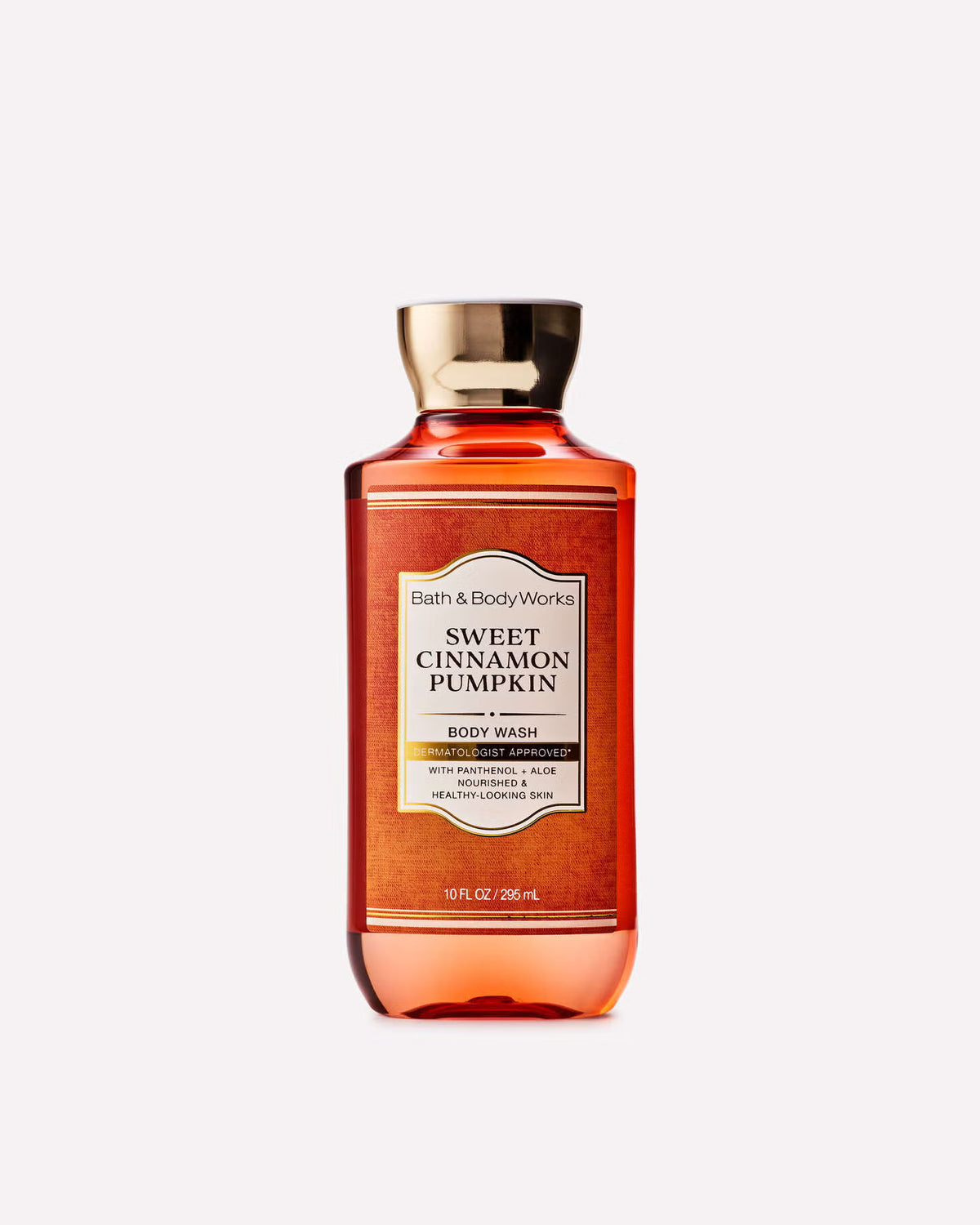 A bottle of Bath & Body Works Sweet Cinnamon Pumpkin body wash, featuring a translucent amber-orange liquid and a metallic gold cap, centered on a light gray background. purchase from www.americanbodycare.co.uk
