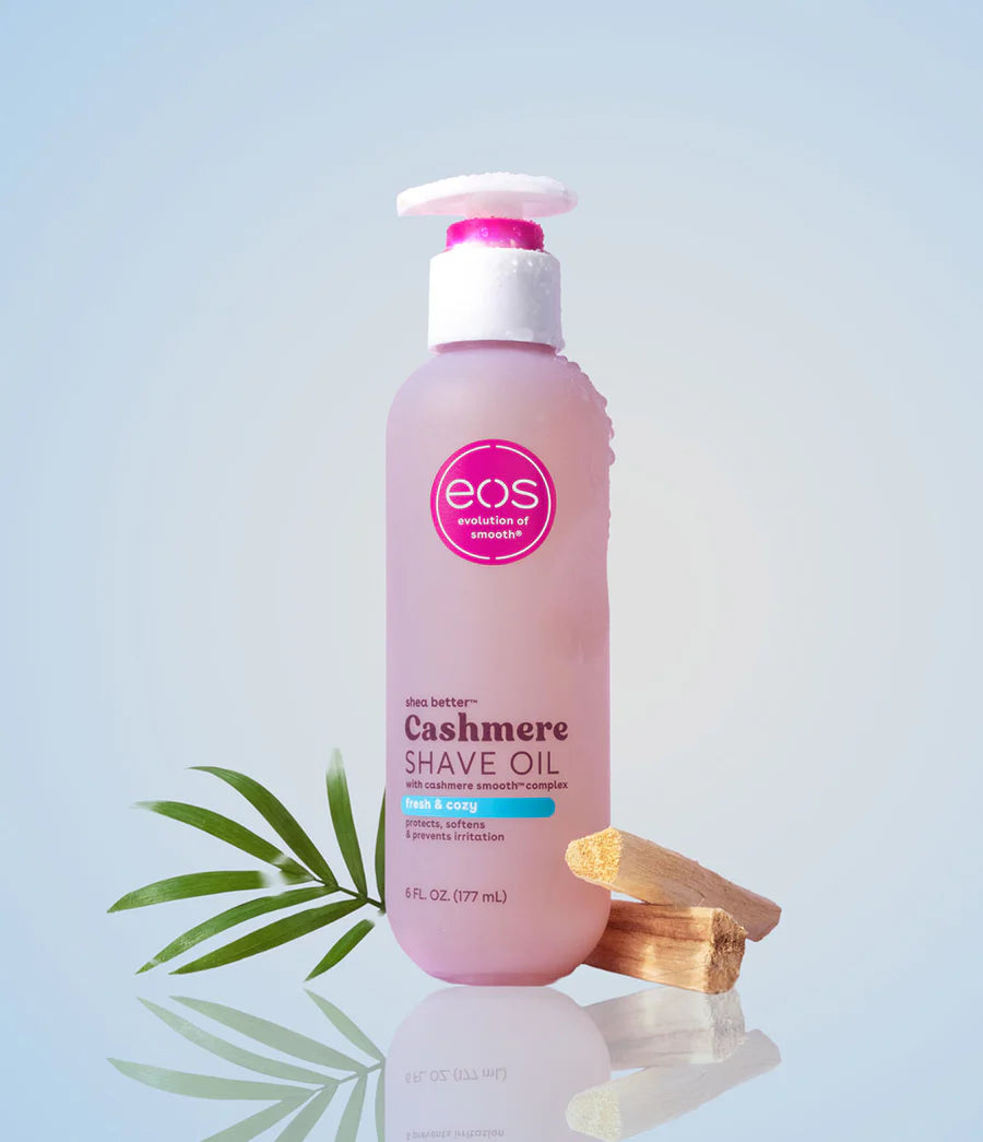 Bottle of eos Cashmere Shave Oil with a pink label on a light blue background. Purchase from americanbodycare.co.uk 